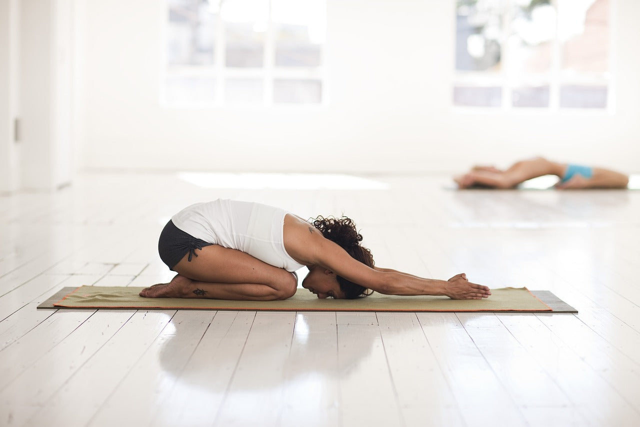 A girl doing yoga indoors