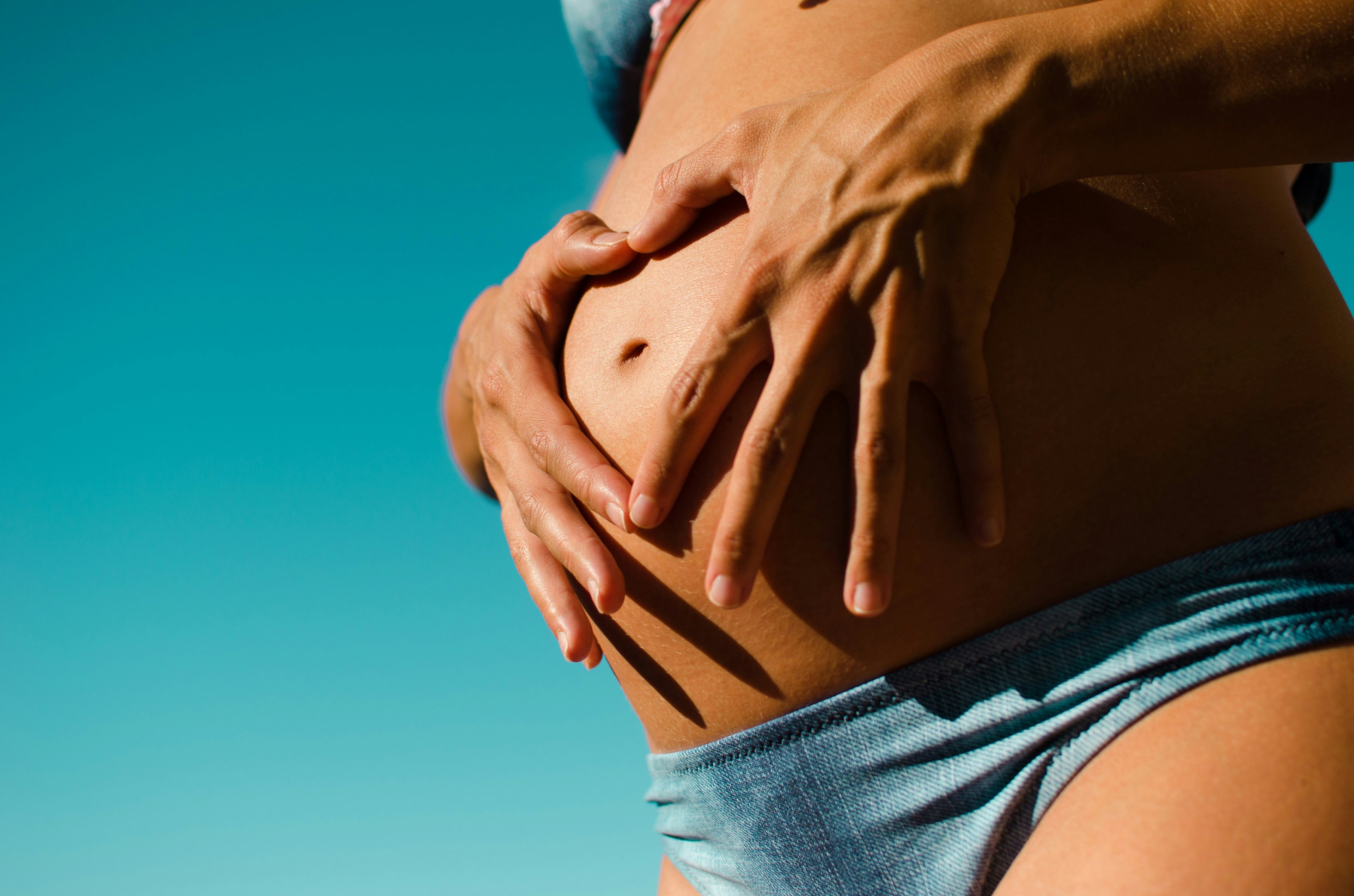 Pregnant woman practicing safe prenatal yoga, promoting relaxation and health for expectant mothers.