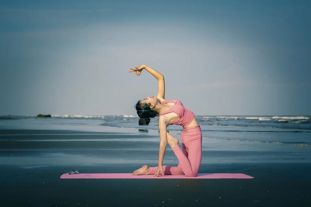 A girl doing yoga on the beach