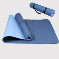 Blue & Dark eco-friendly yoga mat with alignment markers and carrying strap.