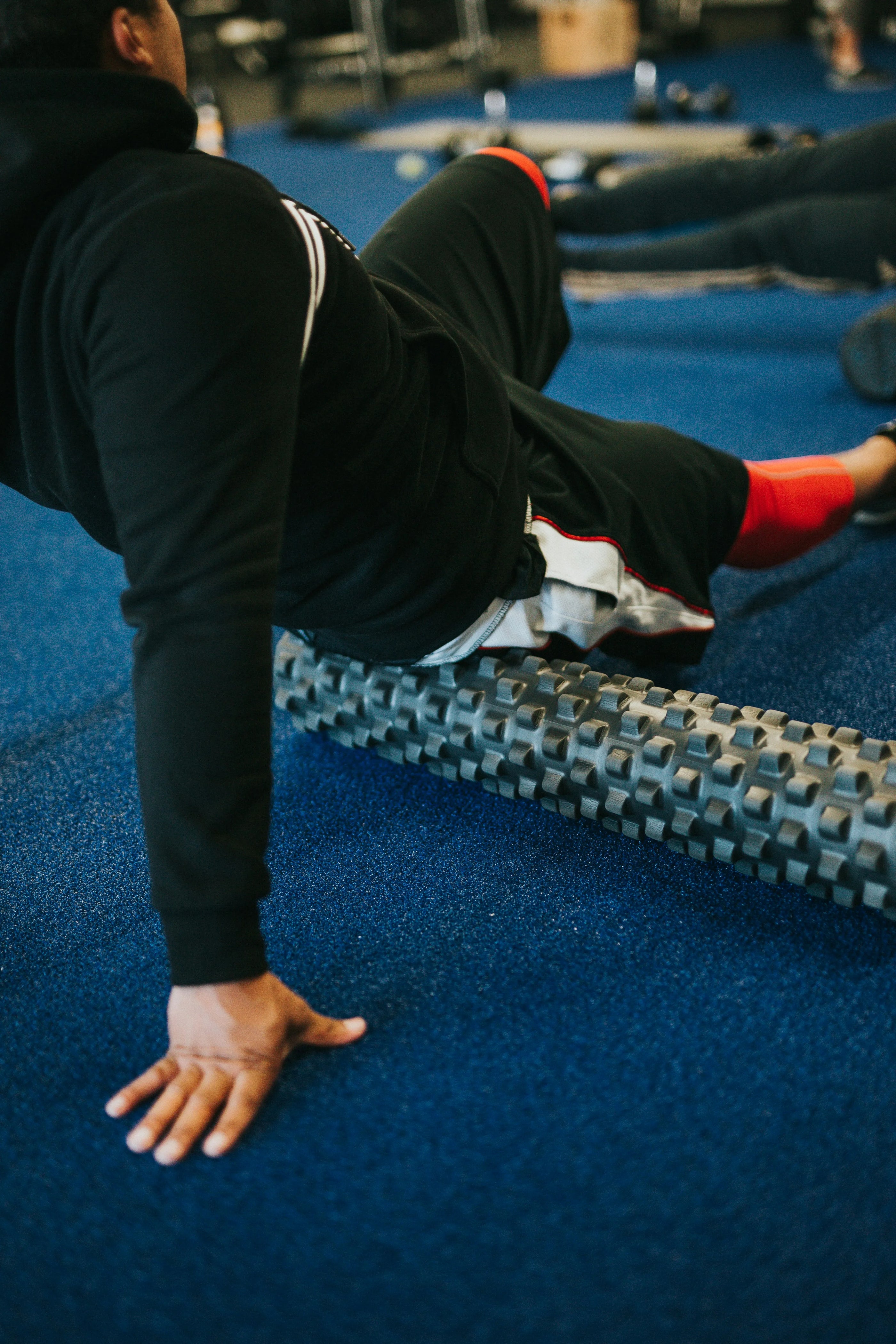 A boy relaxing on a foam roller after a workout