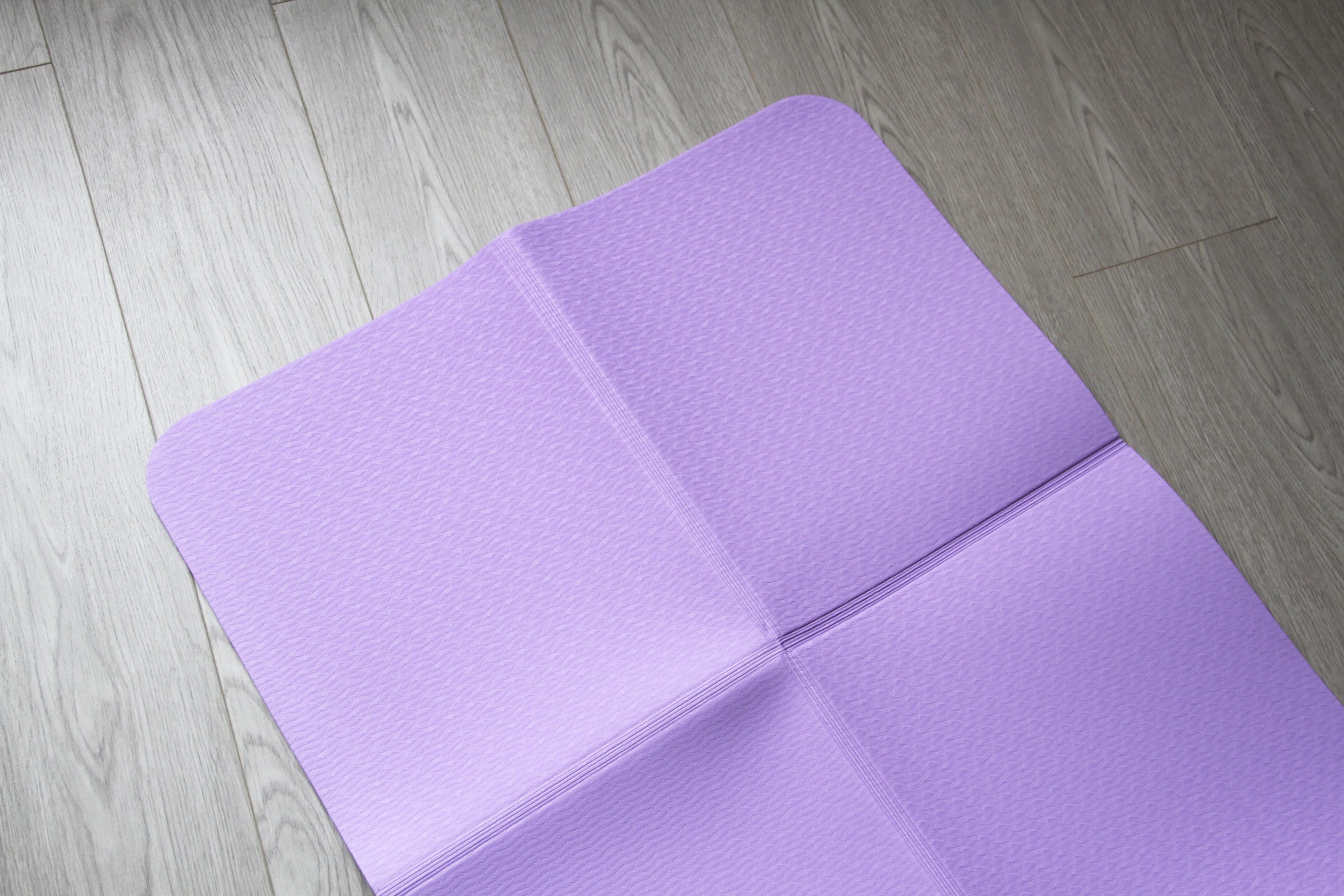 Purple portable folding yoga mat, perfect for easy transport and storage. Available at Sportive Lives in Canada.